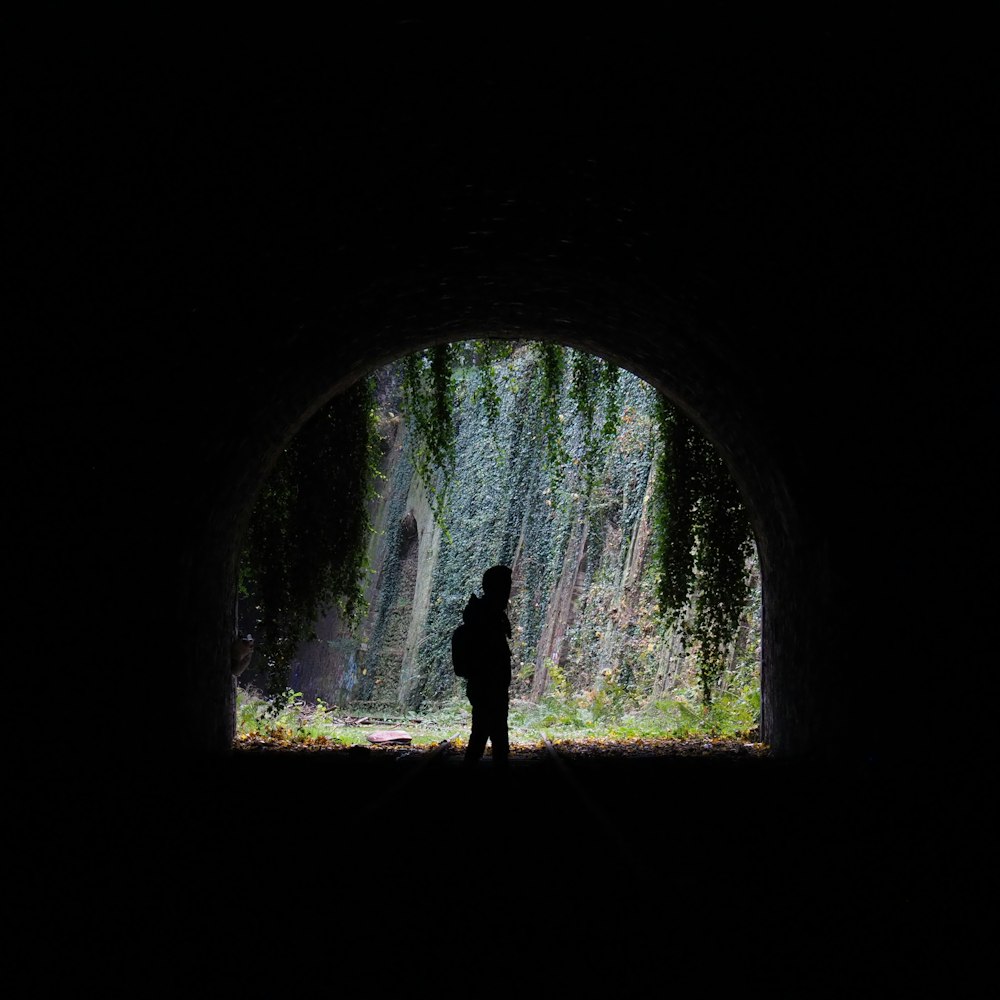 person standing in tunnel