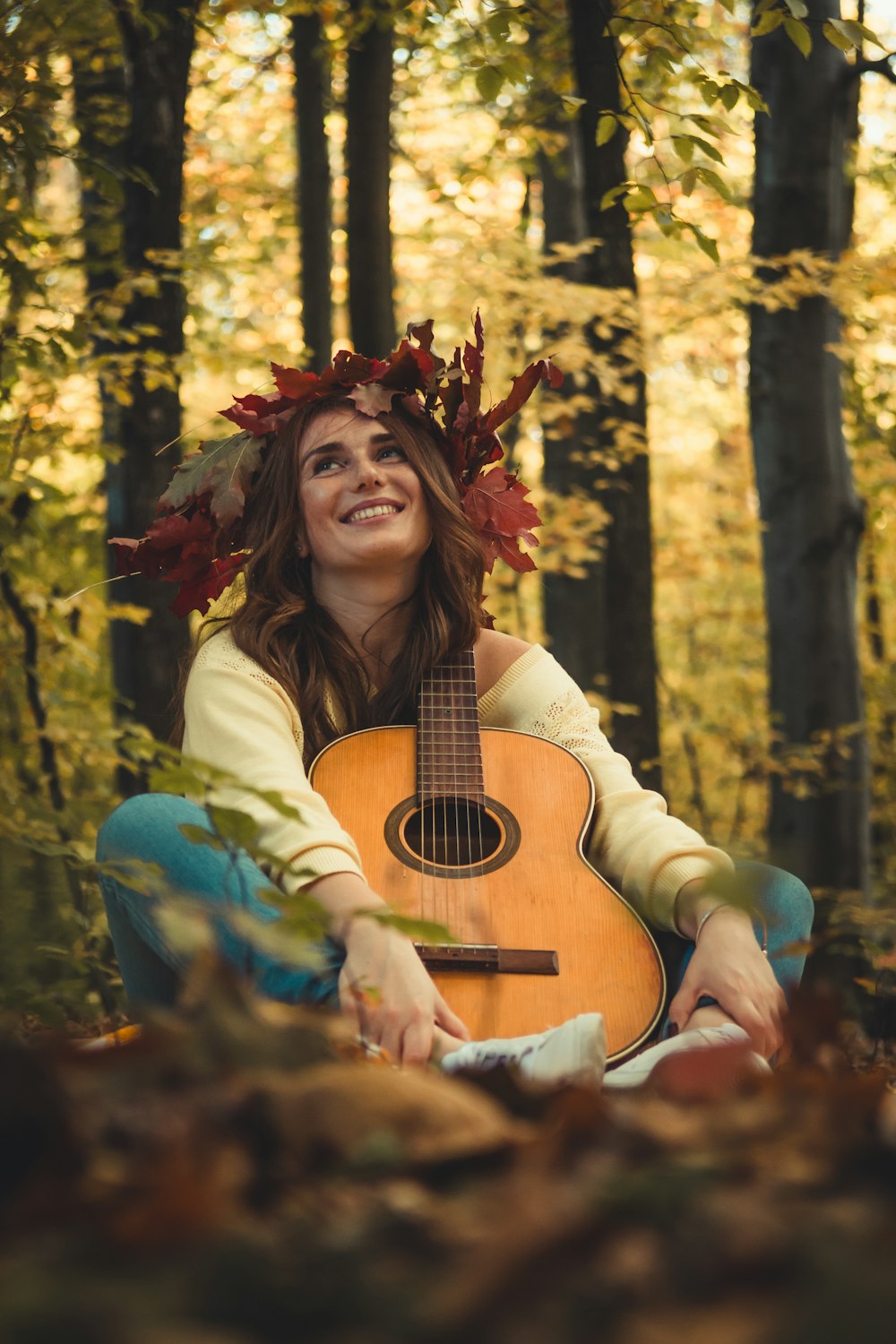 woman with guitar in forest