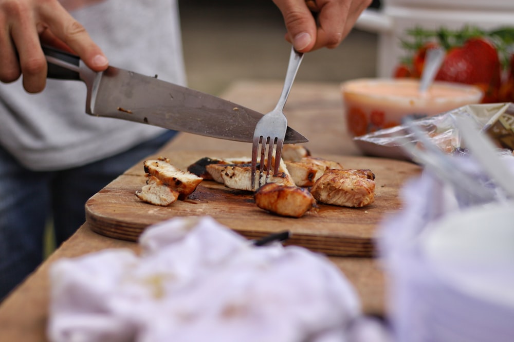 person slicing meat