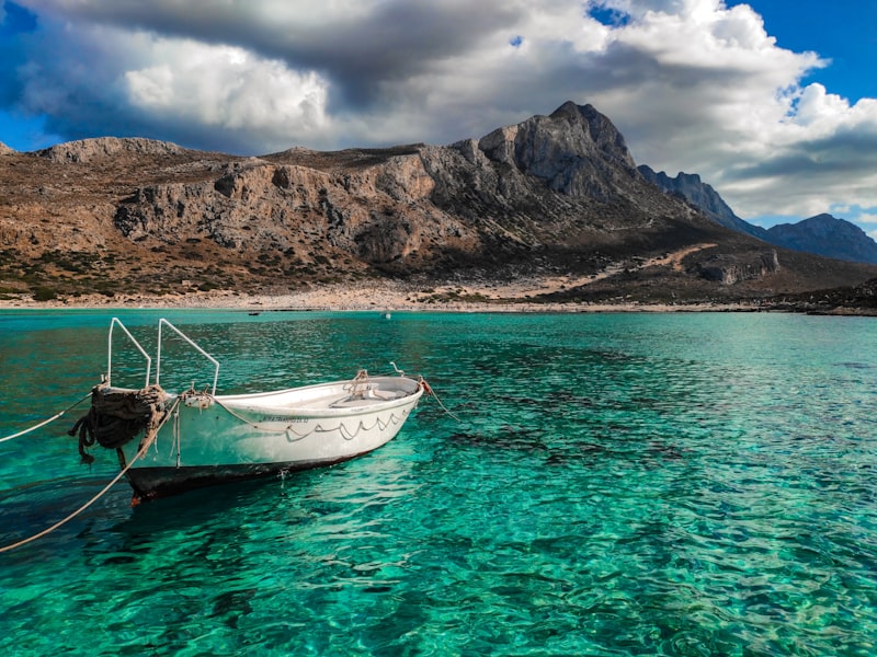 Traditional whitewashed village houses and harbour of Agia Galini, South Crete, overlooking the Libyan Sea