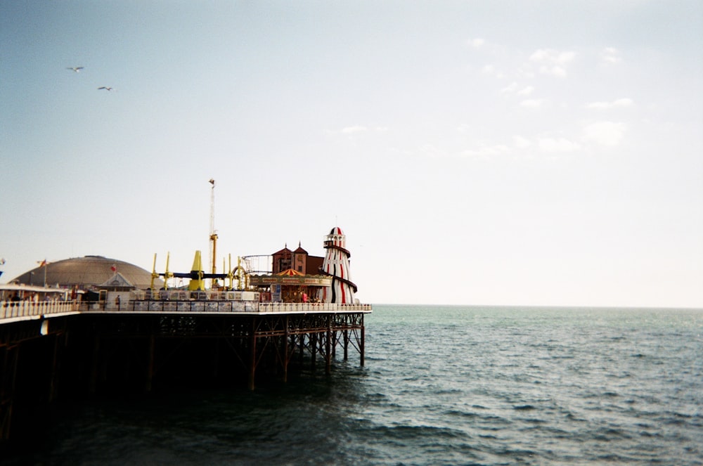 a pier on the water with a sky background