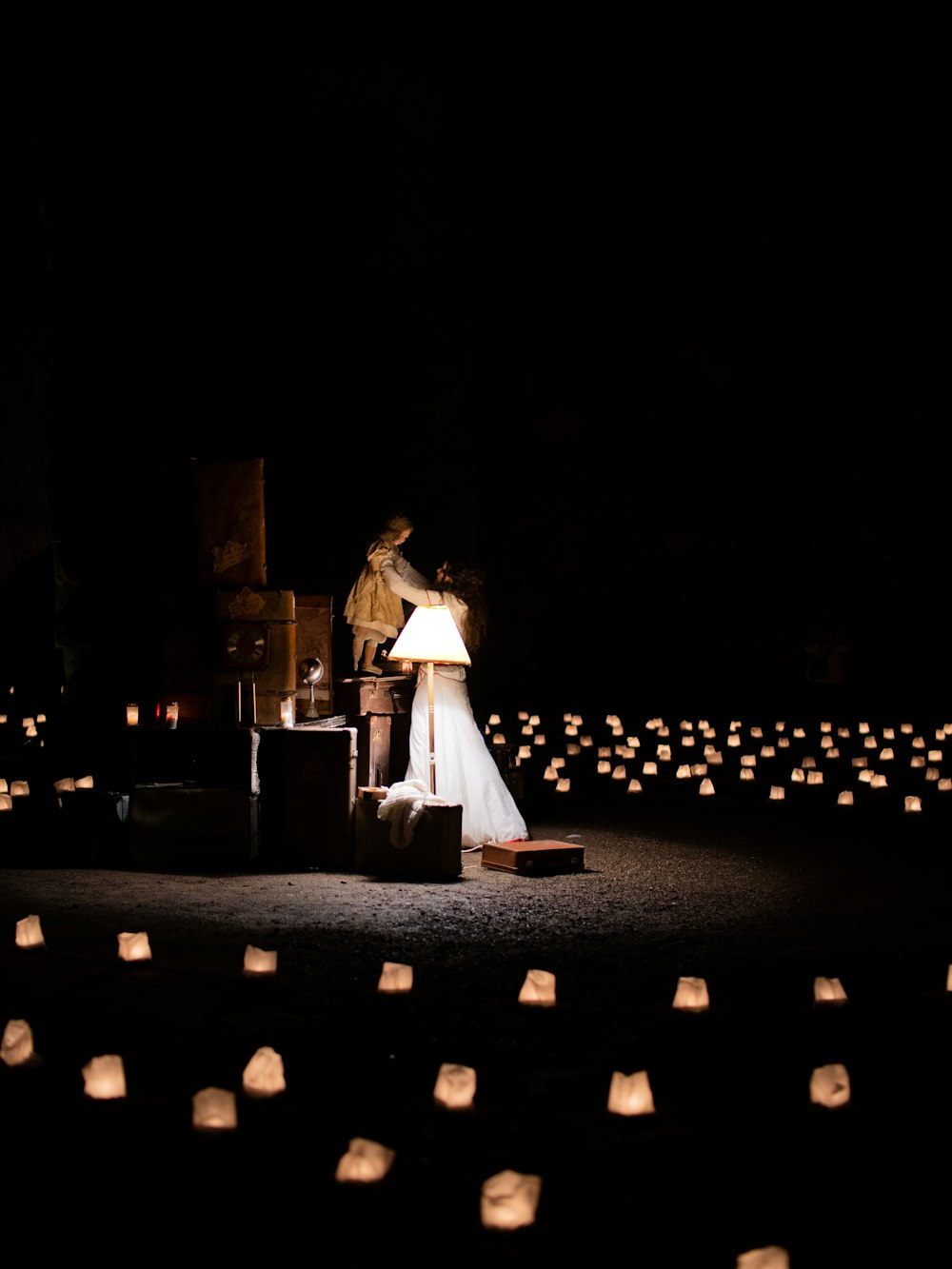 woman standing beside lamp