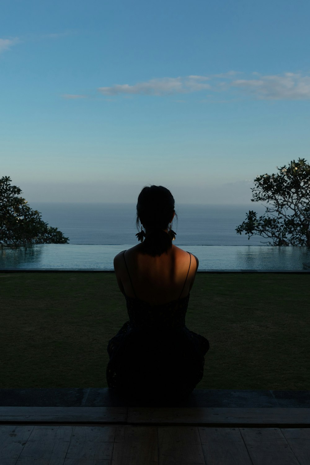 woman sitting on field during daytime