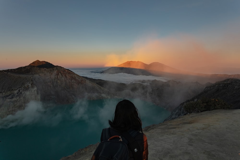 woman standing beside lake