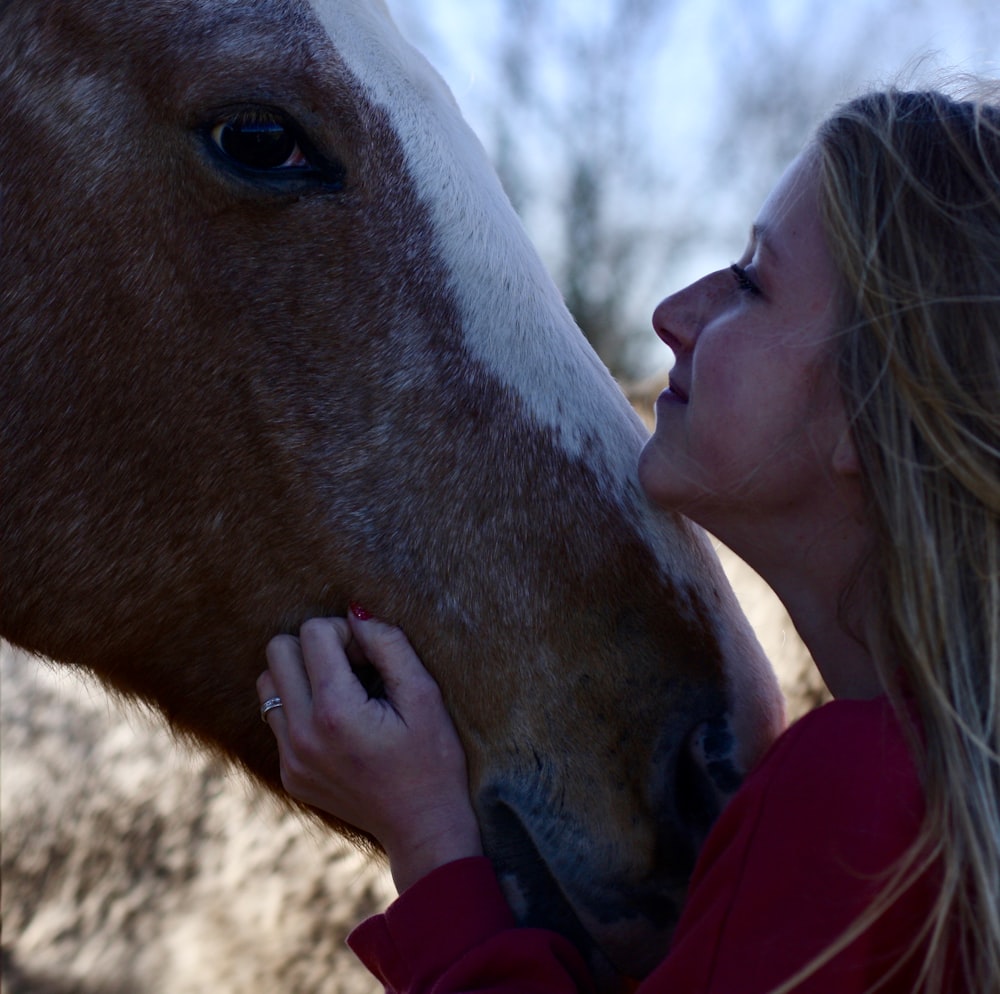 woman holding horse