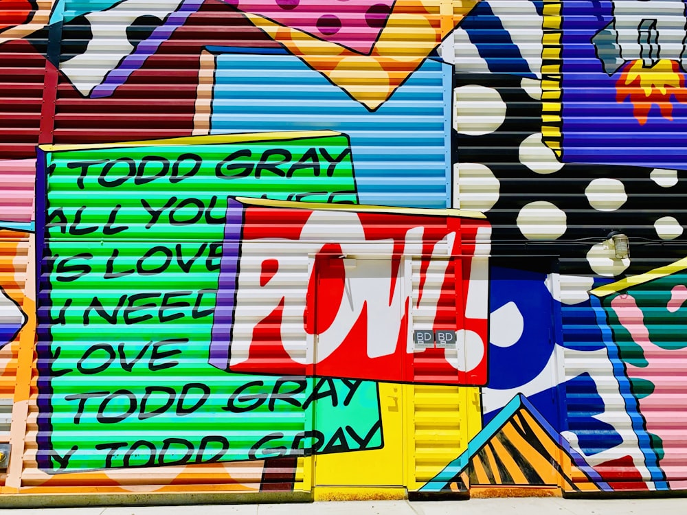 a garage door covered in lots of colorful graffiti
