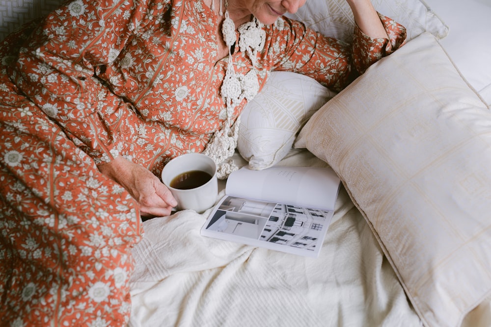 person in brown and white floral long-sleeved shirt lying in bed
