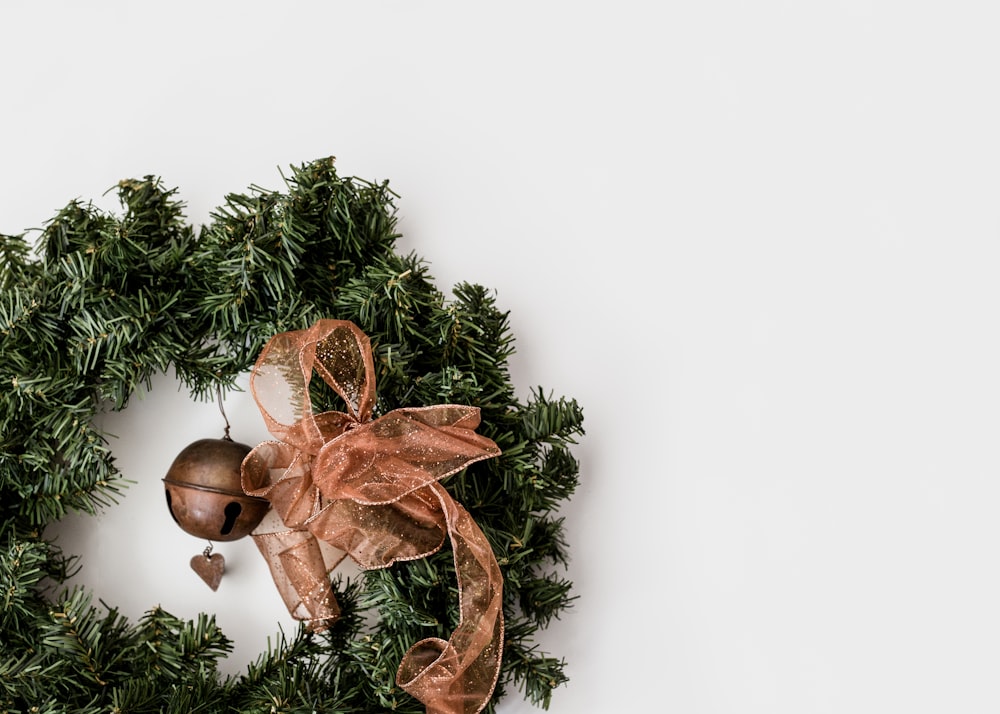 green Christmas wreath on white surface