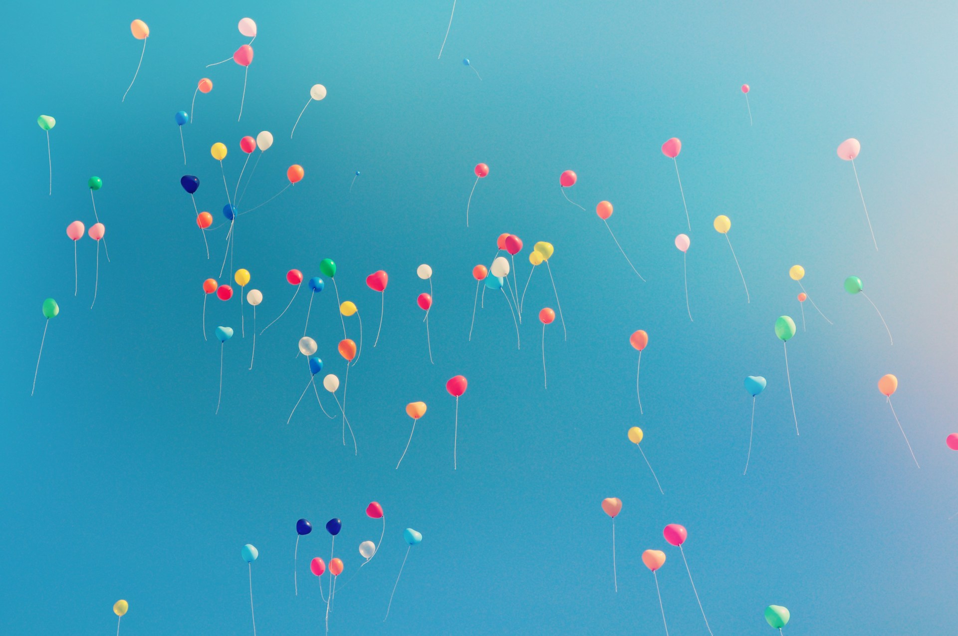 assorted colored balloons mid airs