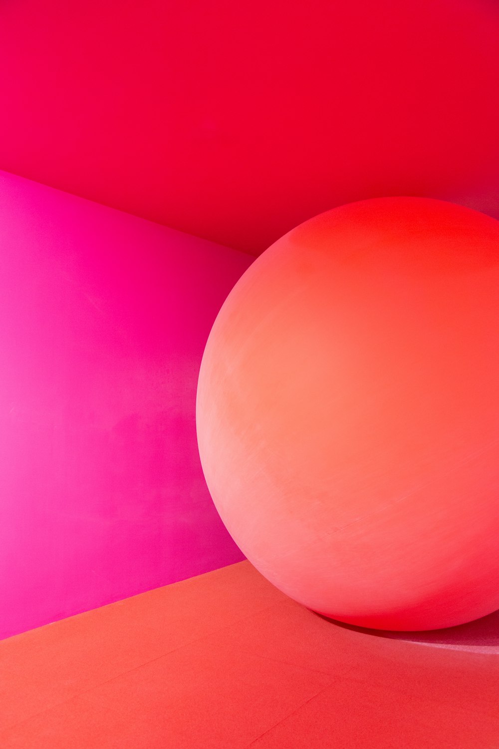 a large pink ball sitting in a room