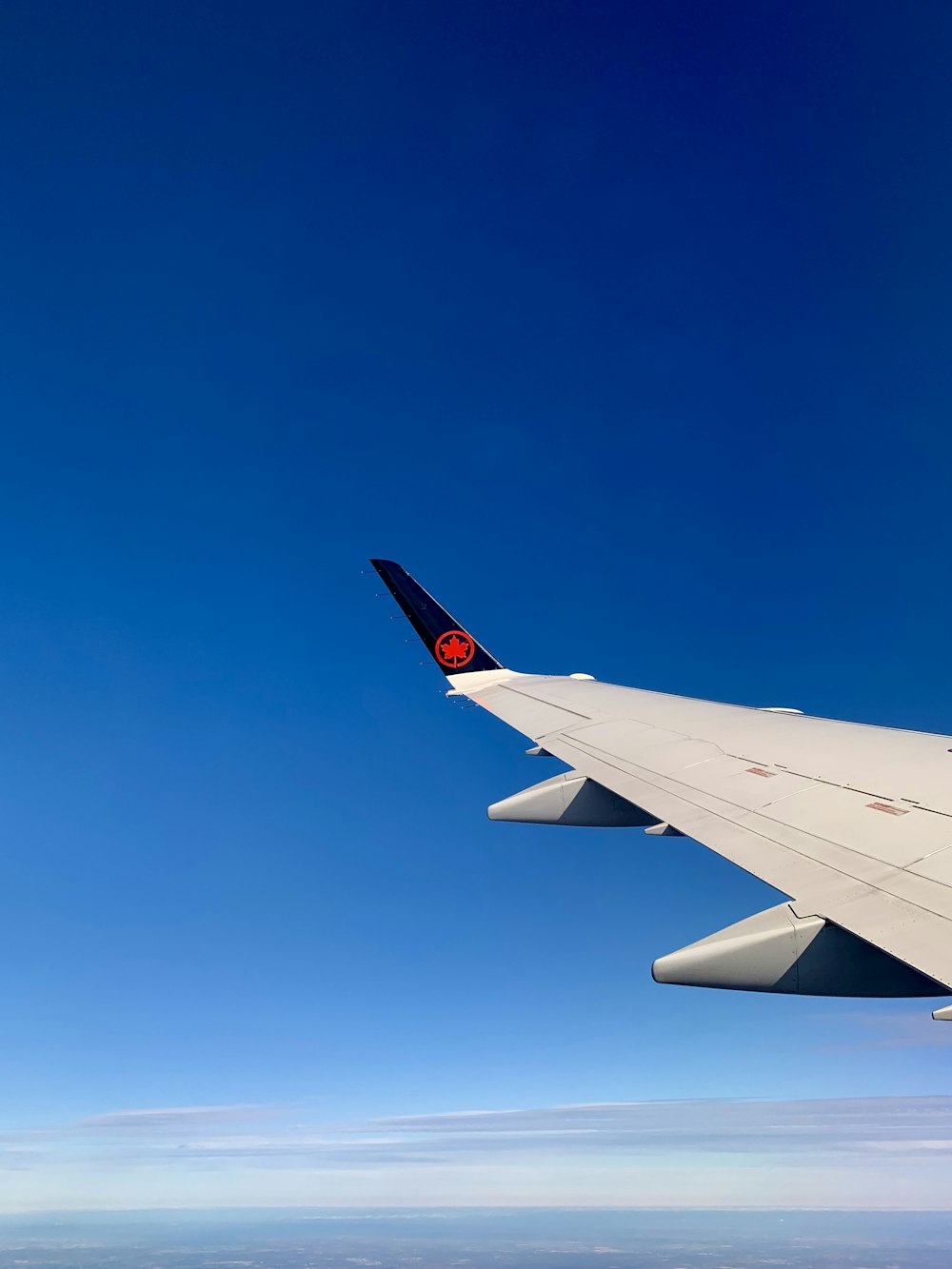 white and red airplane on sky