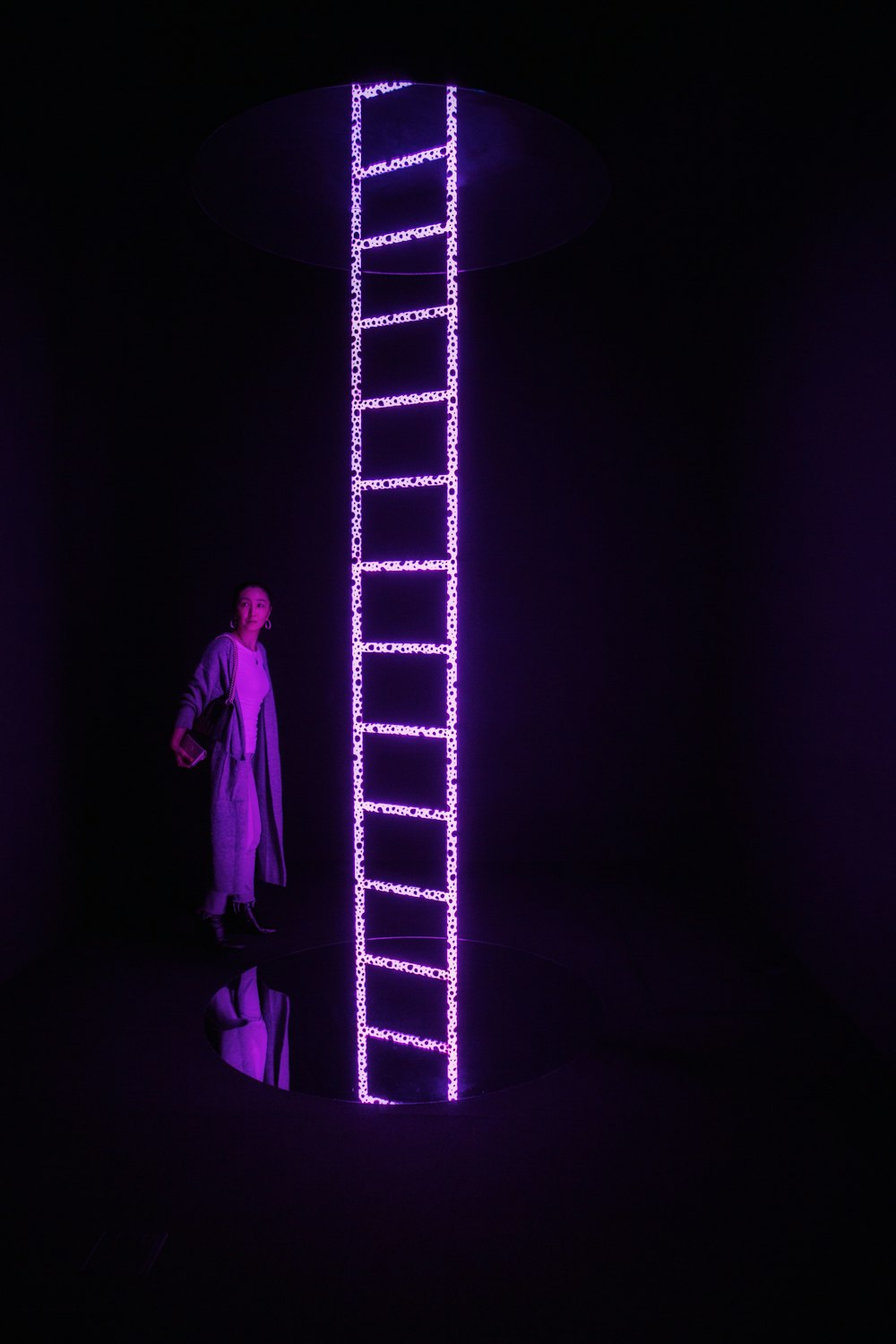 woman standing near lit frame