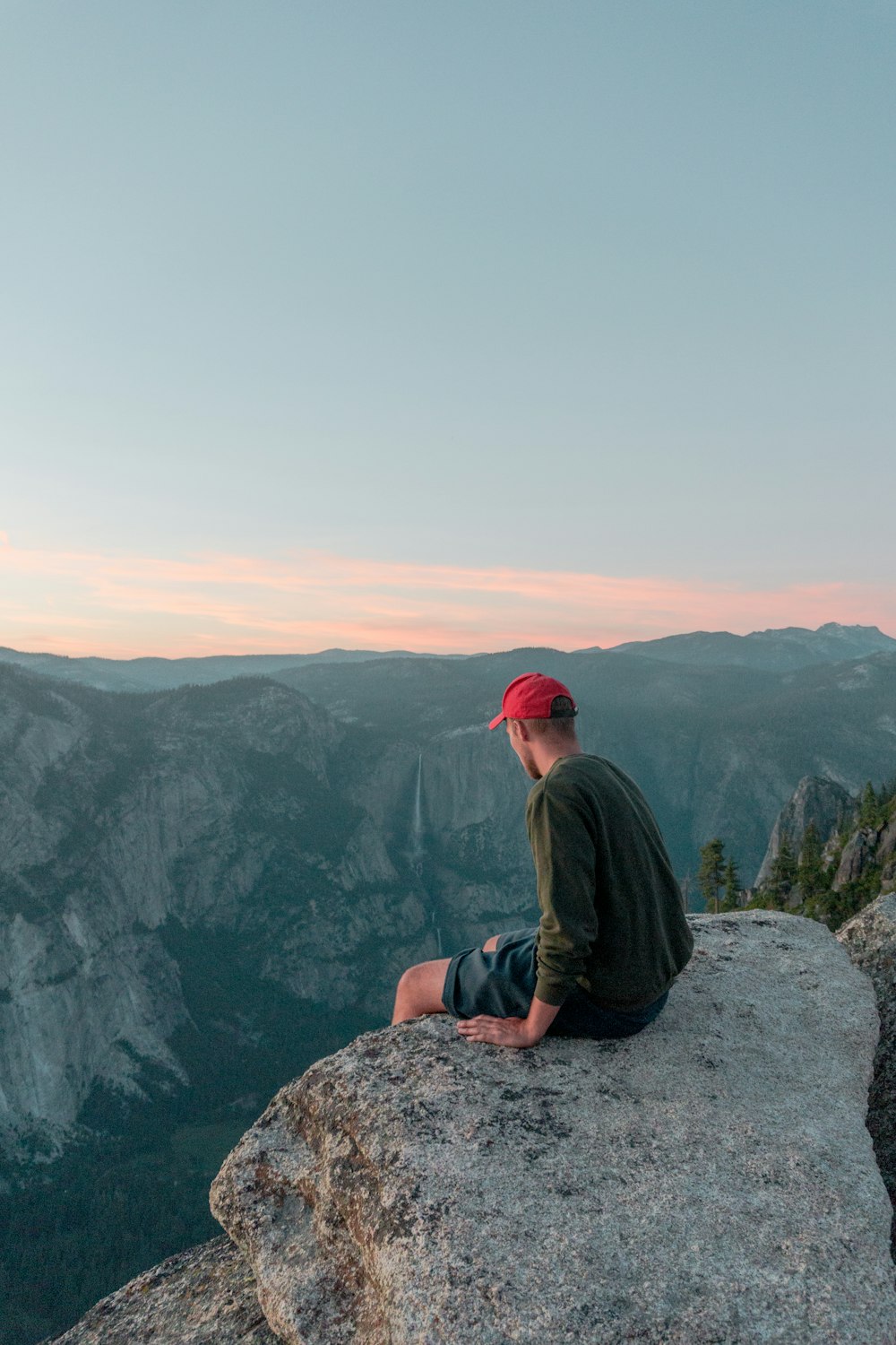 man sitting on rock