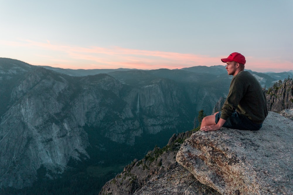 man sitting on rock