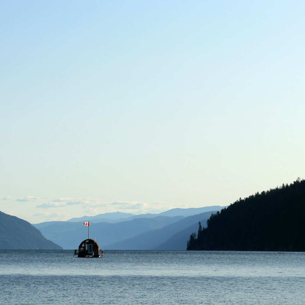 boat on body of water near mountains