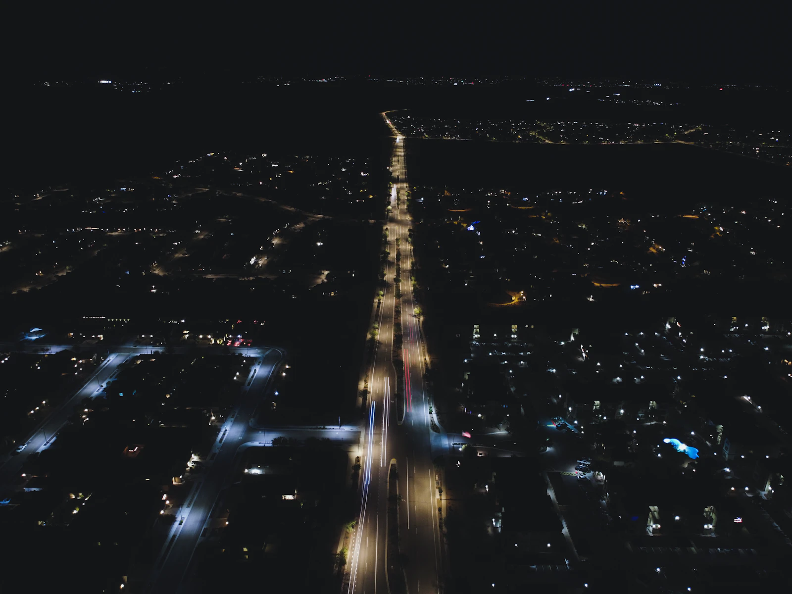 An aerial view of street lights along an urban road at night
