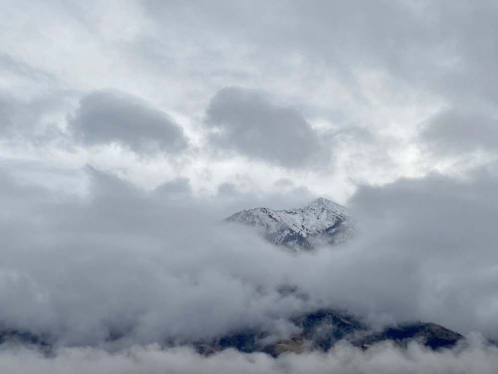 view photography of mountain covered by white clouds