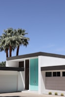 Completed home exterior showcasing clean lines and turquoise accents.