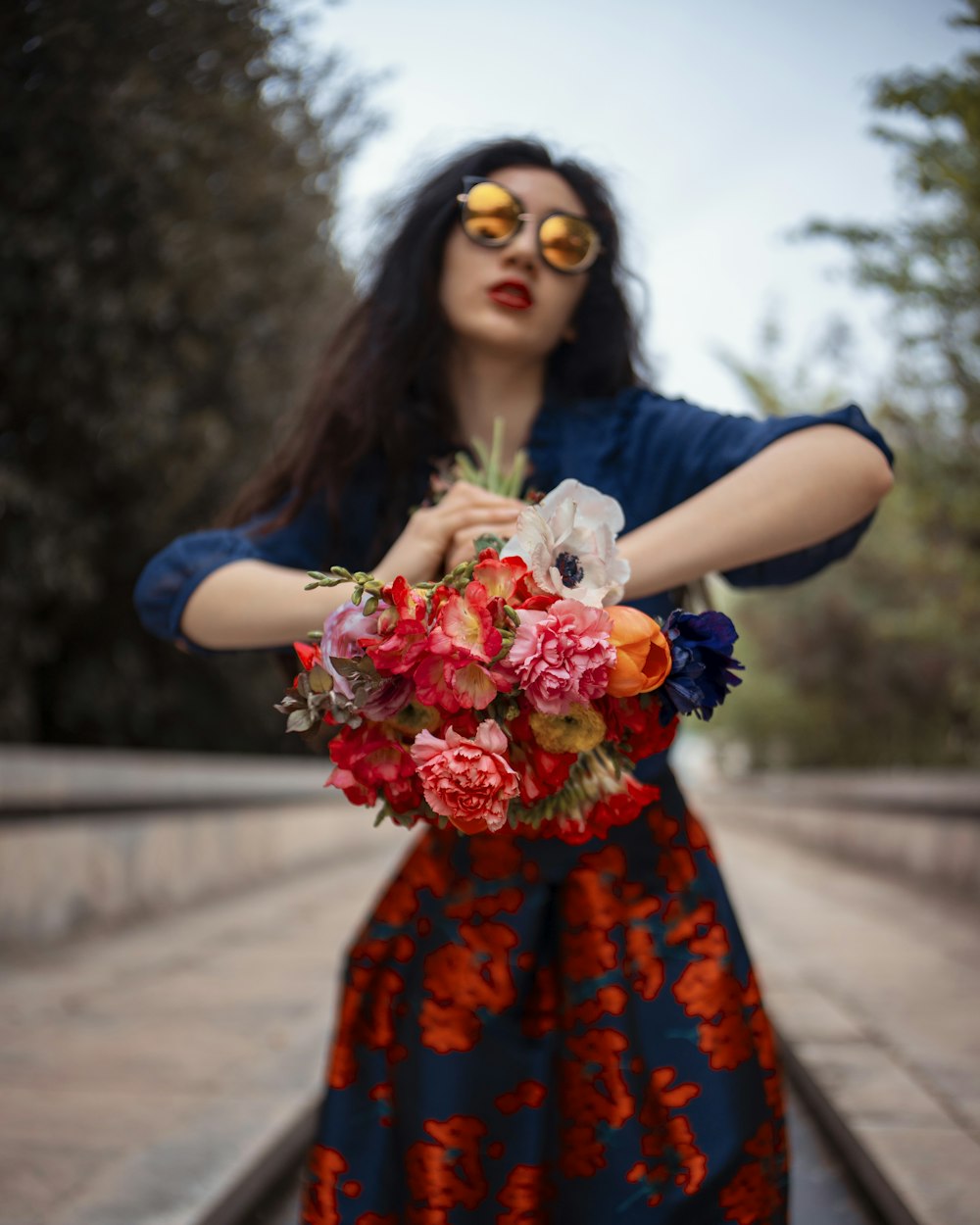 woman wearing blue elbow-sleeved dress