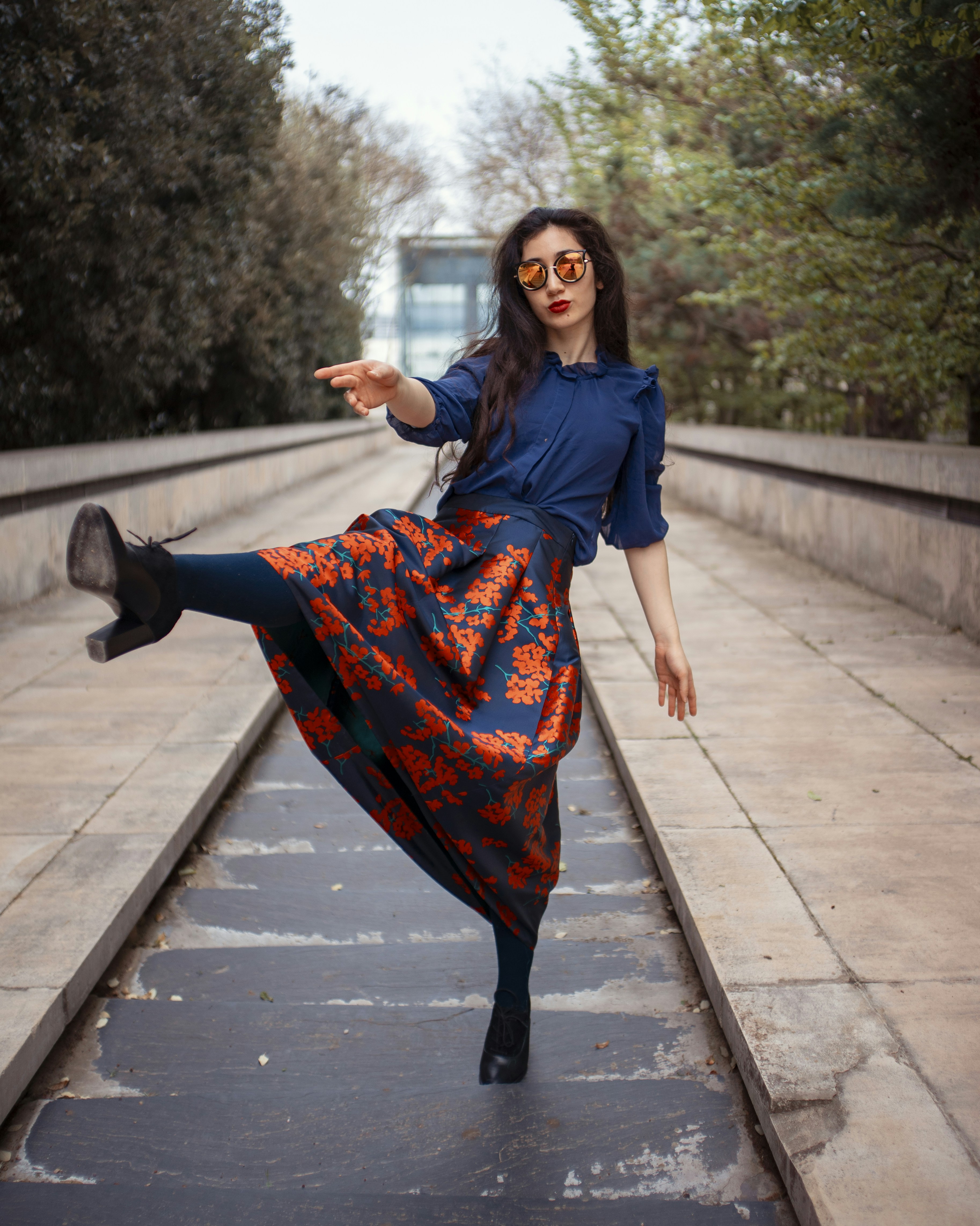 woman wearing blue and red floral skirt