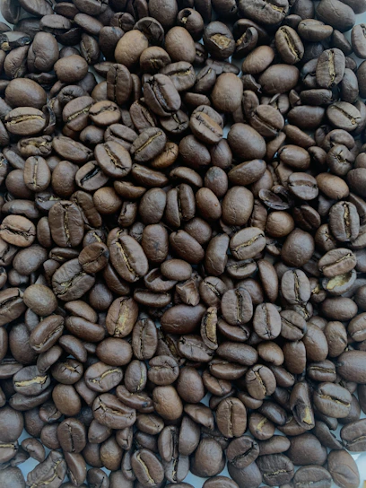 Close-up of freshly roasted coffee beans with steam rising.