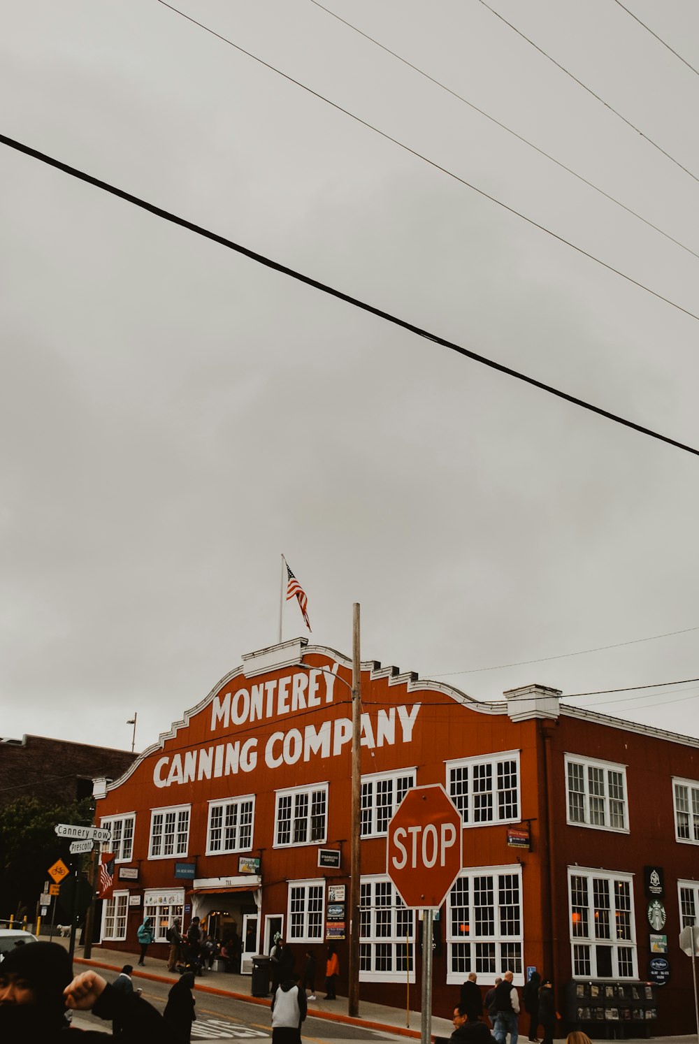 people walking near Monterey canning company building during daytime