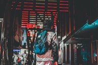 Evening shot of a person wearing a Lumina jacket under city lights, highlighting reflective details.