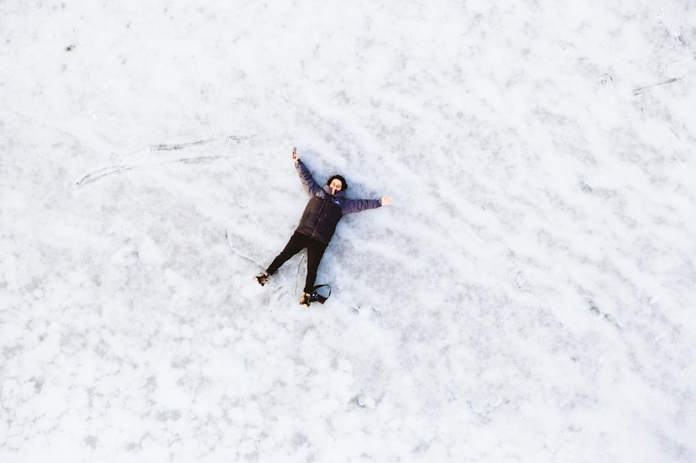 person lying on snow