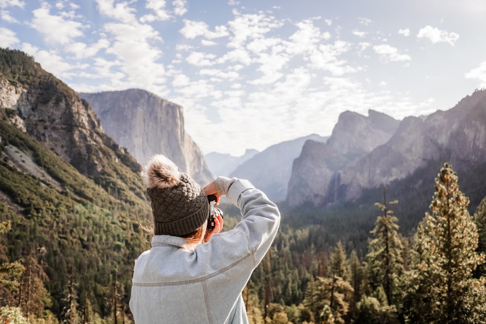 person taking photo of mountain ridge