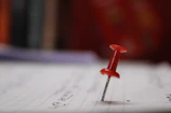 Close-up of a mini case study sheet pinned to a corkboard with notes.
