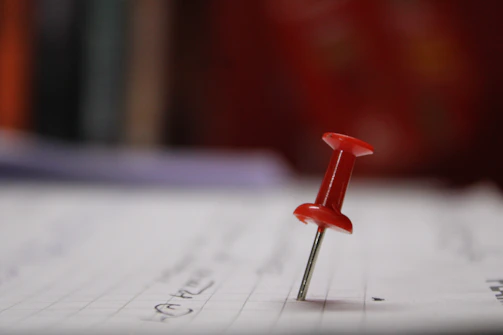 Close-up of a mini case study sheet pinned to a corkboard with notes.