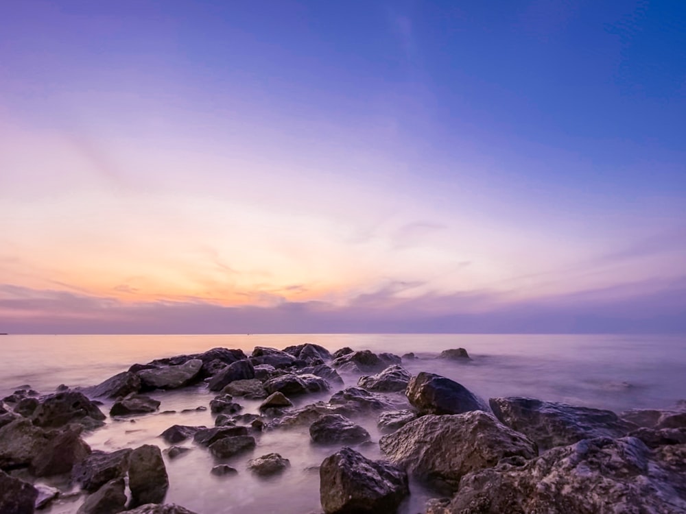 stones on calm body of water