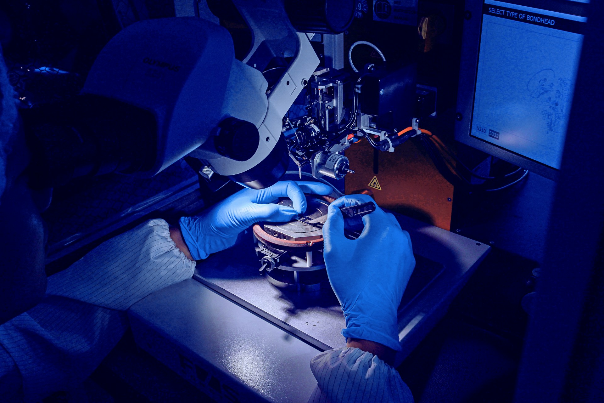 a person in blue gloves operating a machine