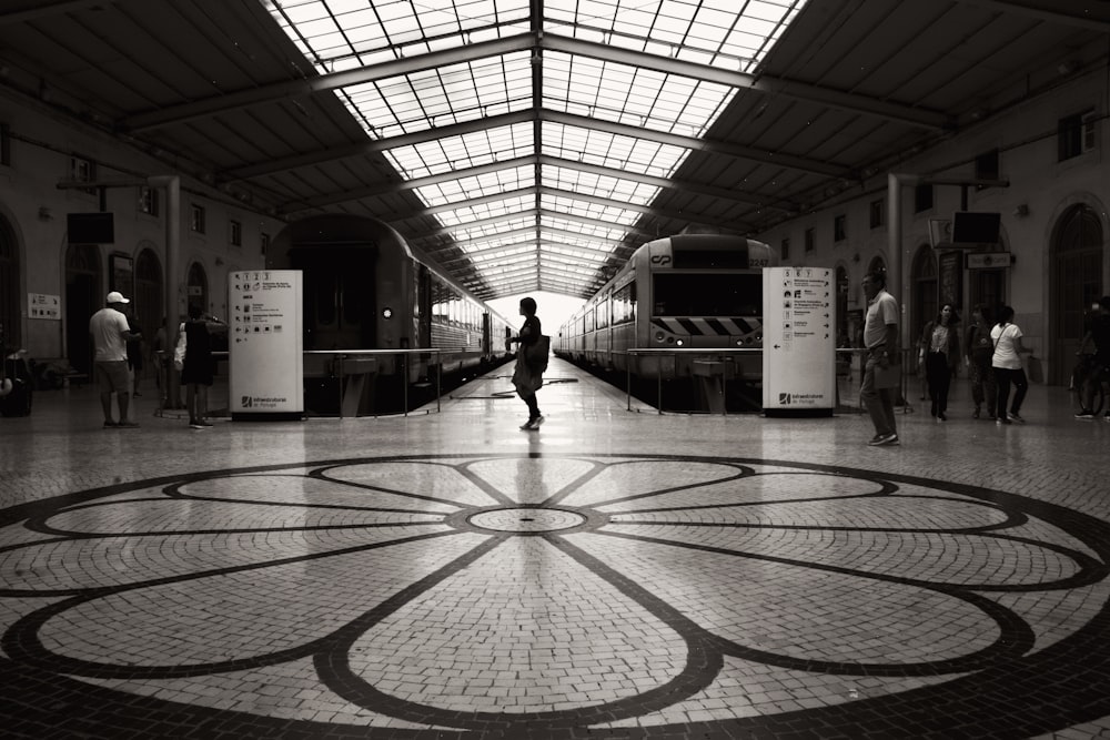 grayscale photography of people near train