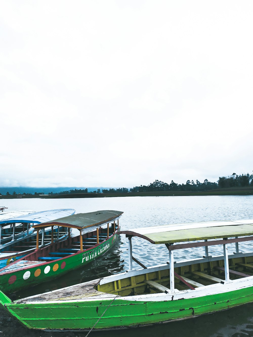 green boats docked on docking area