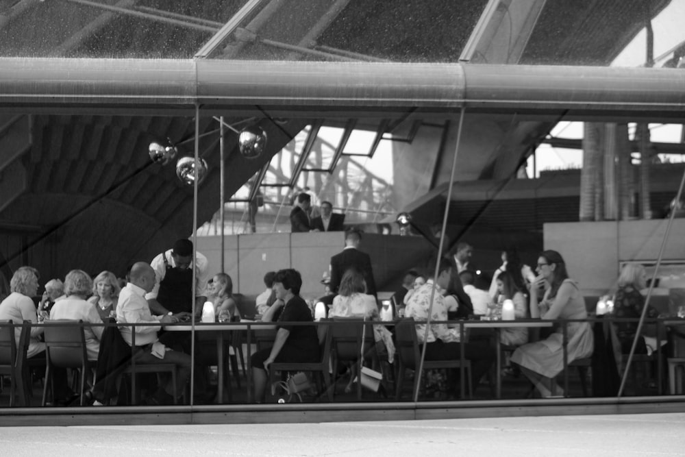 grayscale photo of group of people gathering