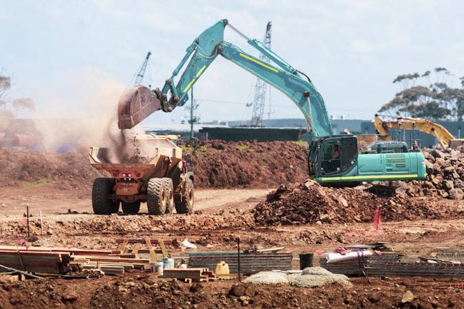photography of excavators operating at site