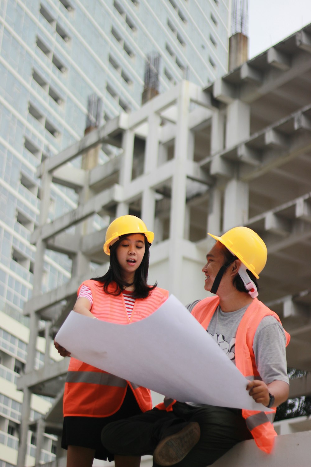 man and woman holding white paper