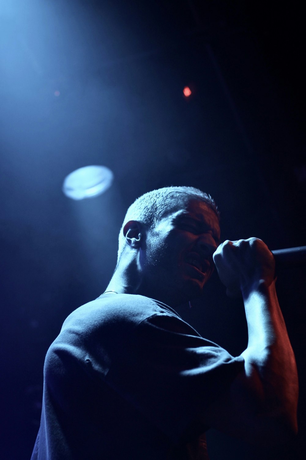 man holding microphone performing on stage