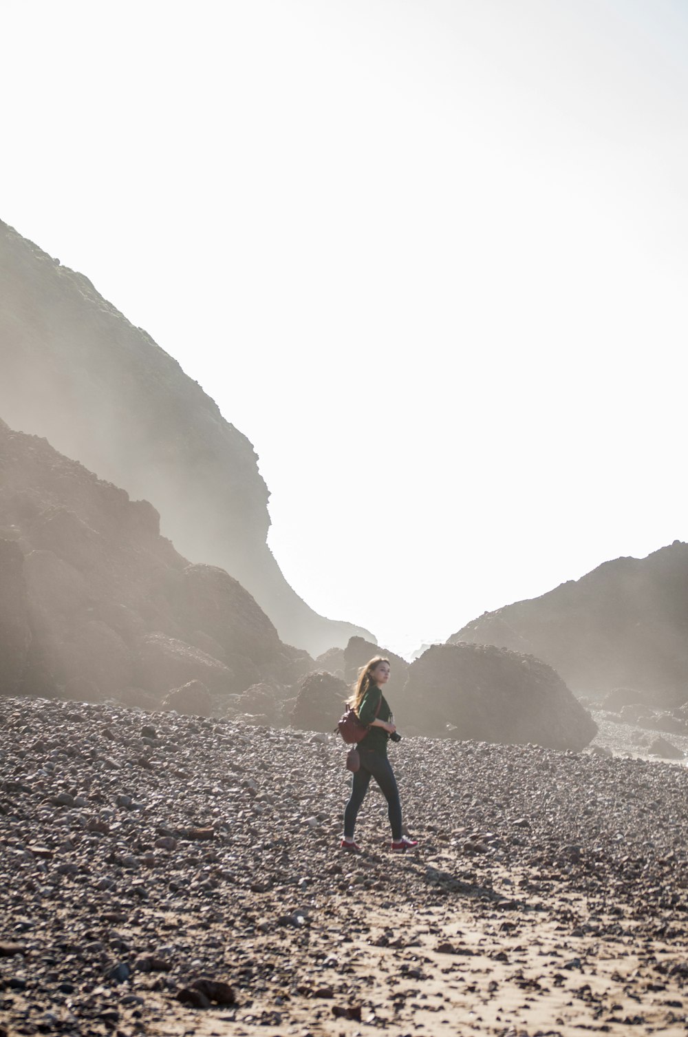 woman wearing black jacket walking on mountain