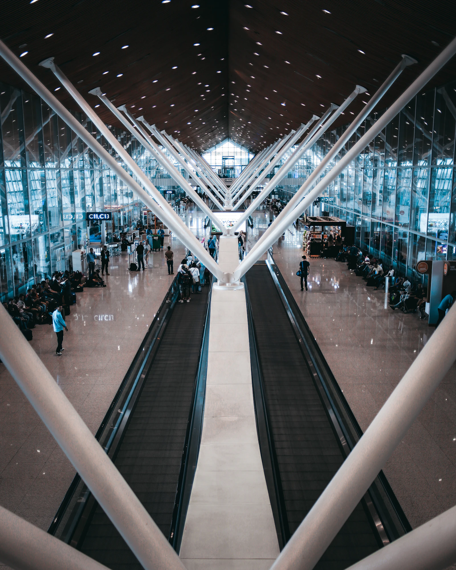 Travelers moving through a modern airport terminal