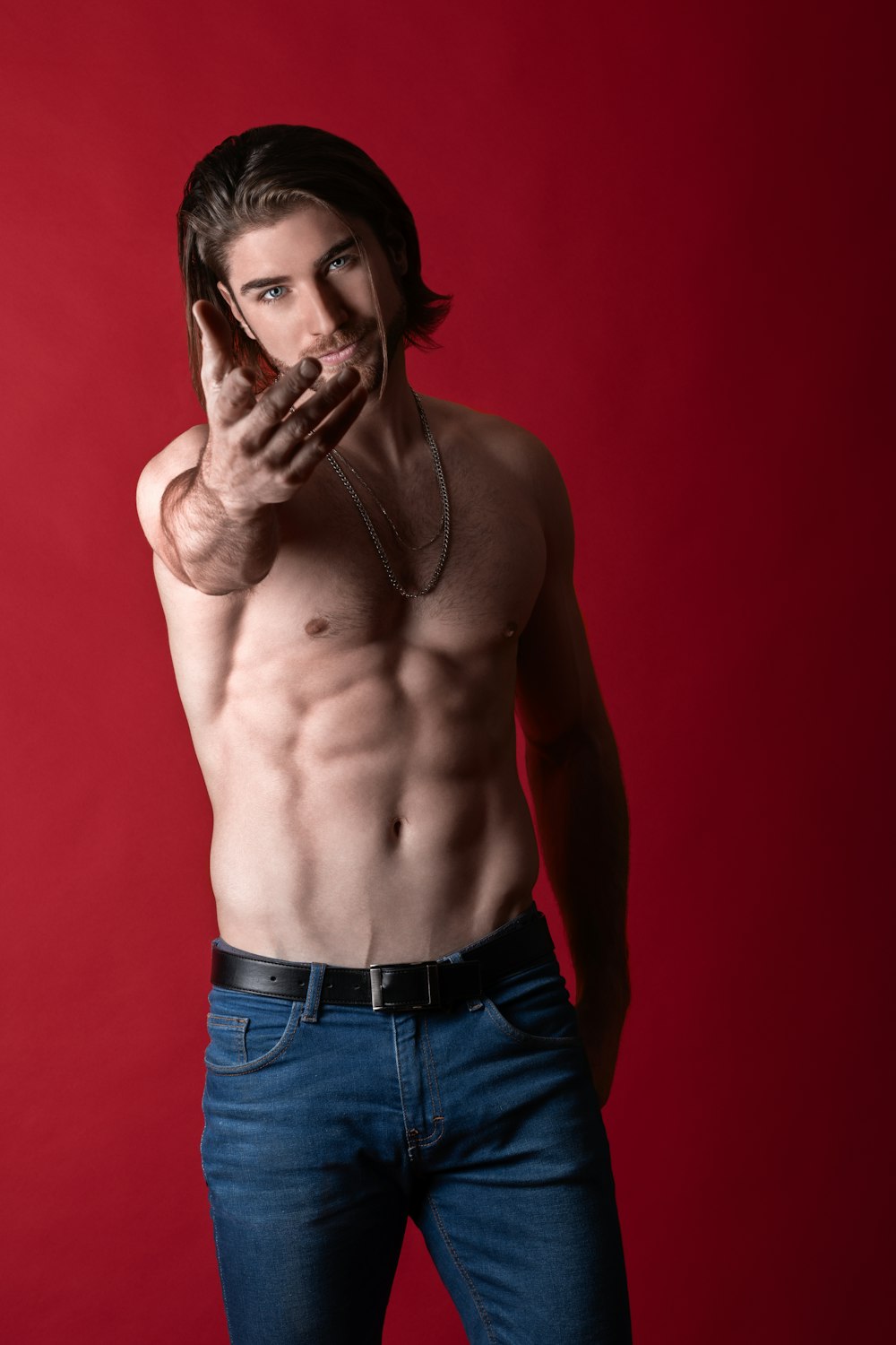 topless man wearing blue jeans