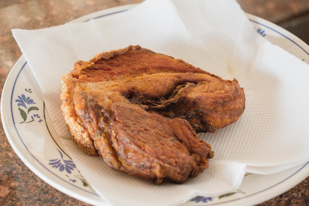 fried meat on tissue on plate