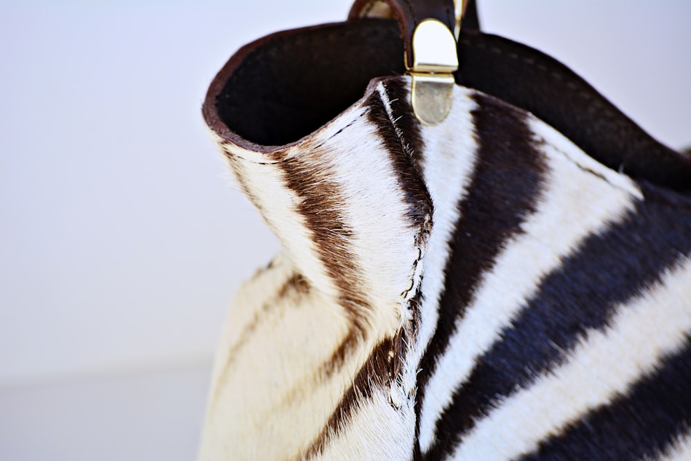 a close up of a zebra print purse