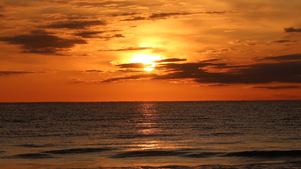 time-lapse photography of rippling waves during golden hour