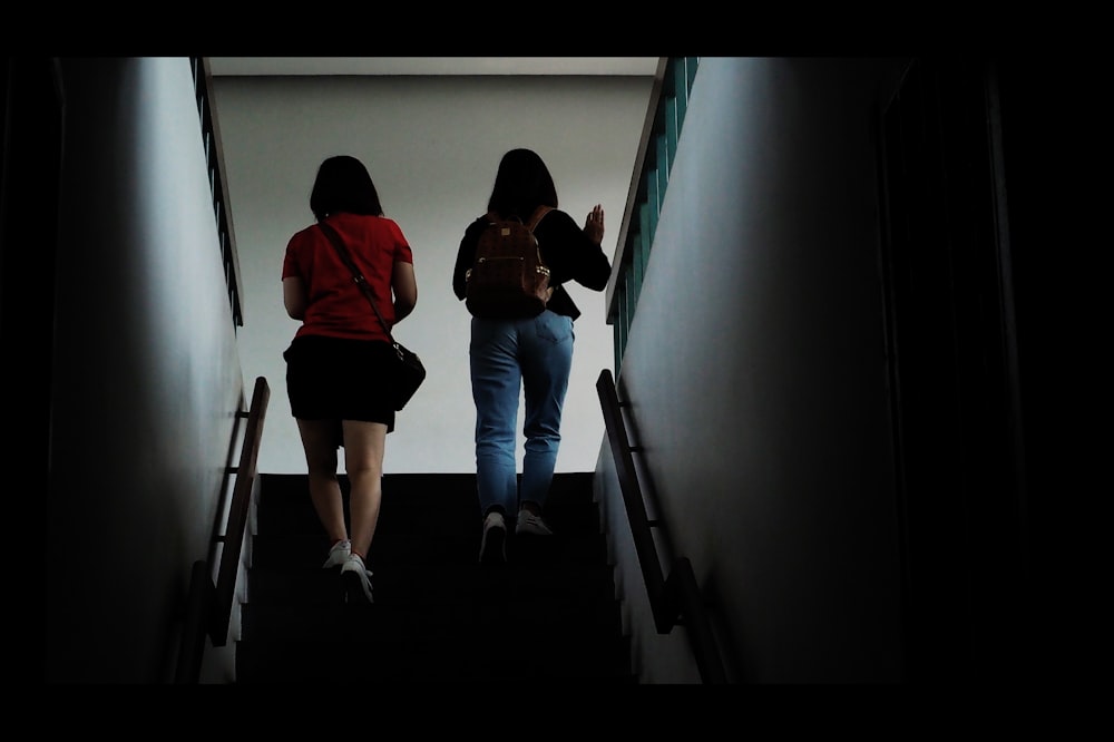 two woman standing on stairway