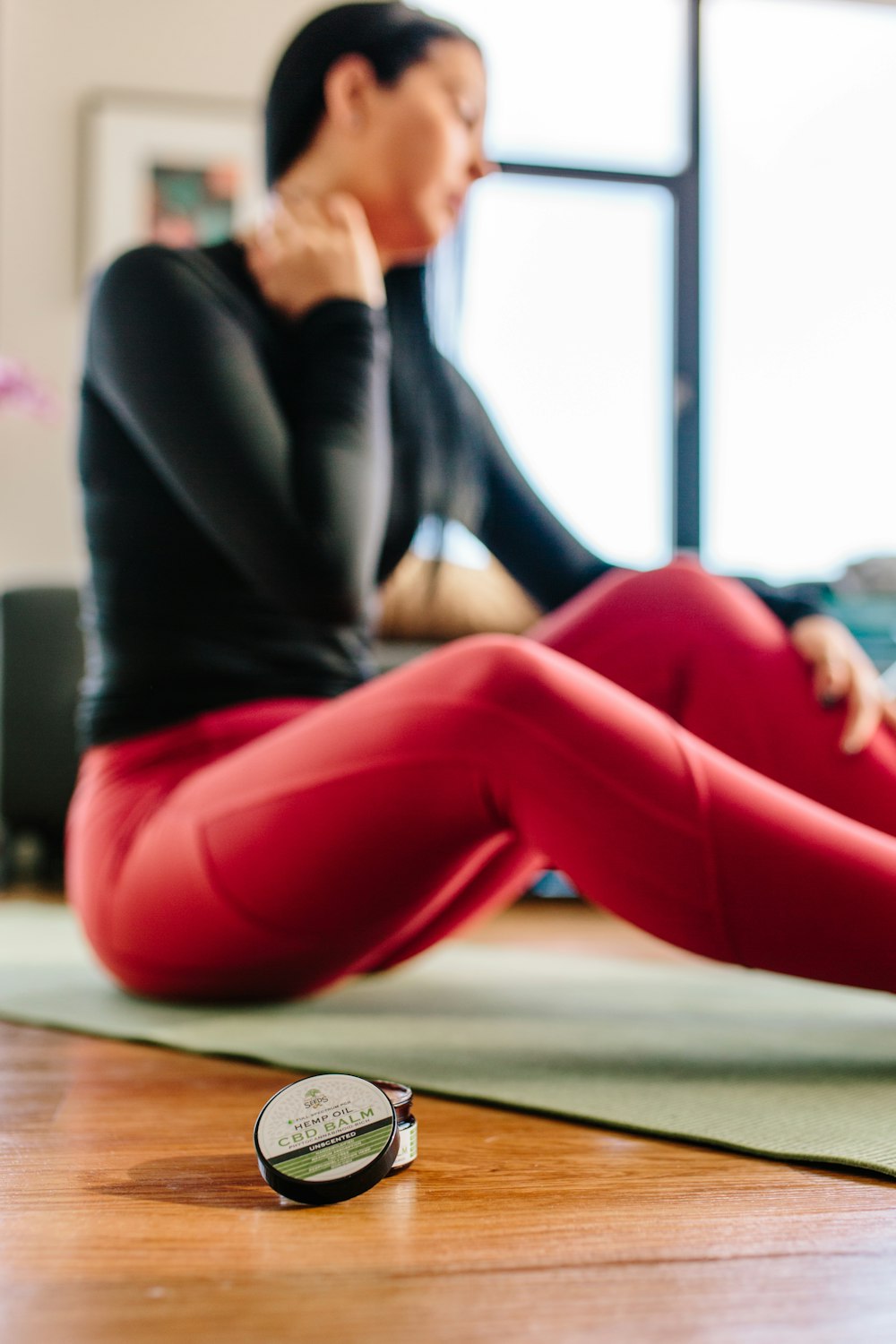 woman sitting on yoga mat