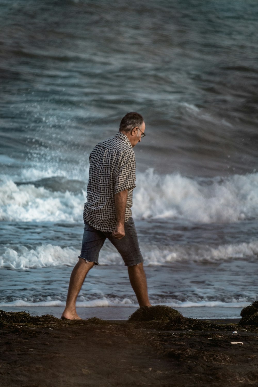 man walking near the body of water photograph