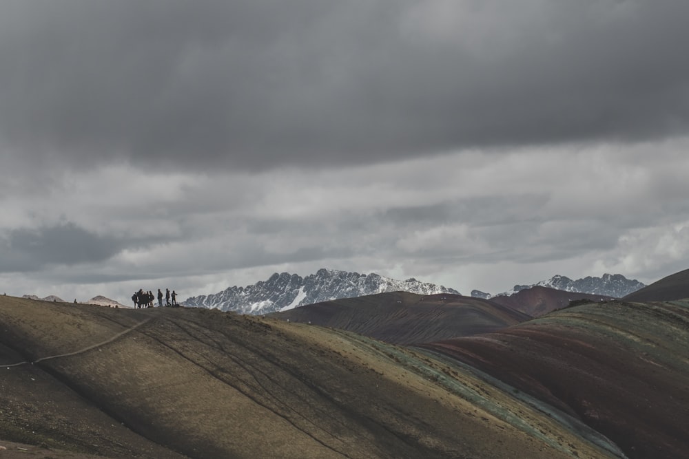 group of person on the mountain cliff