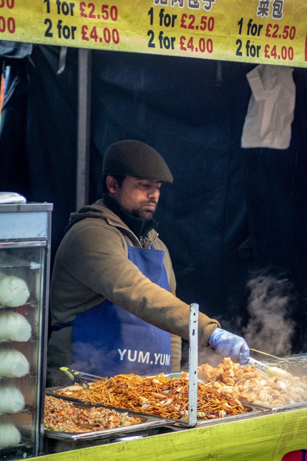 shallow focus photo of man wearing blue apron